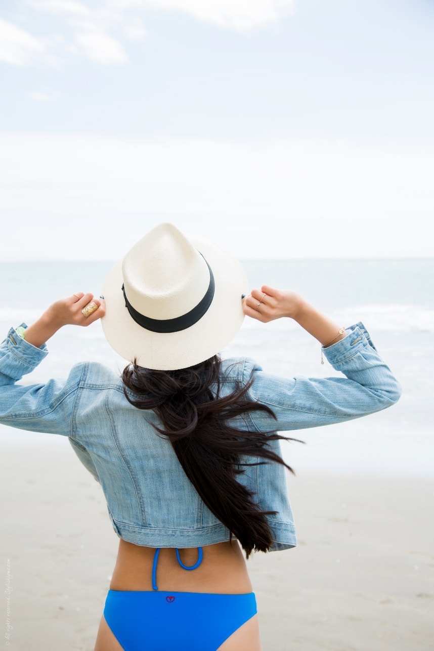 Wearing denim jacket and hat on the beach - Visit Stylishlyme.com for more outfit inspiration and style tips